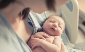 mother holding sleeping infant