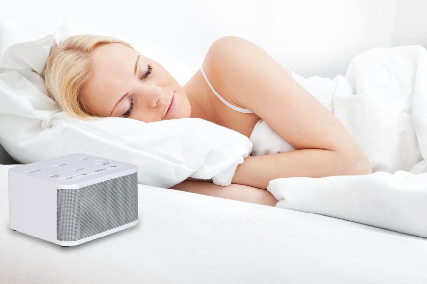 woman sleeping with white noise machine