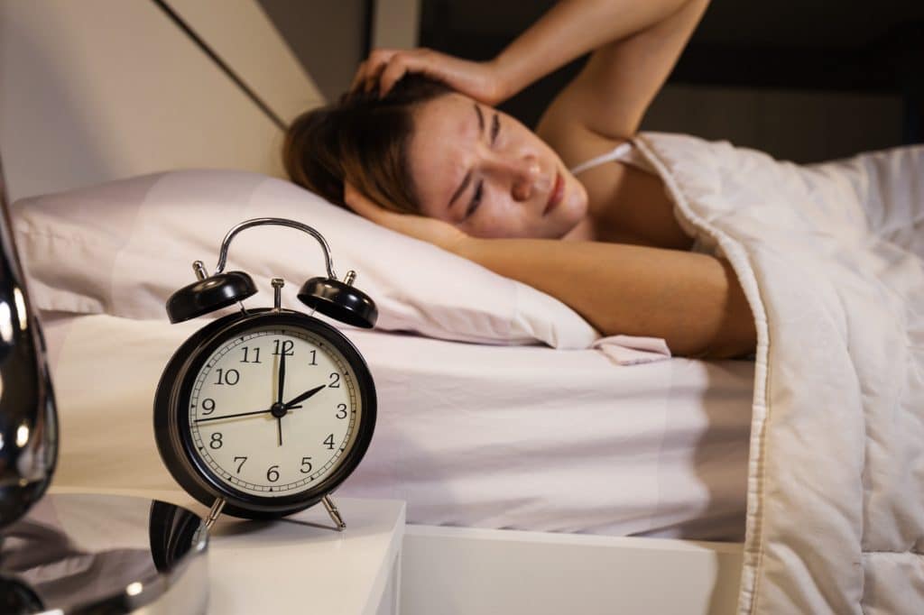 Woman struggling to sleep in the middle of the night